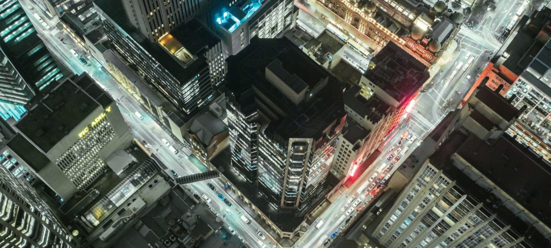 crossroads-cars-skyscrapers-at-night