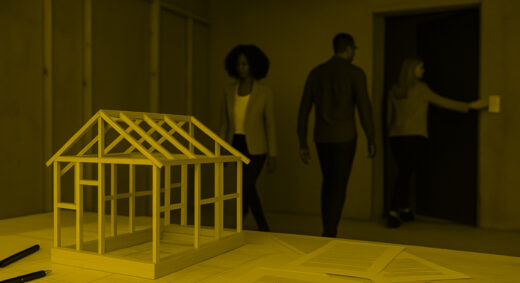 A picture showing three people leaving a room, in which stands a model of a house and documents strewn about a table. They are turning out the lights as they leave.
